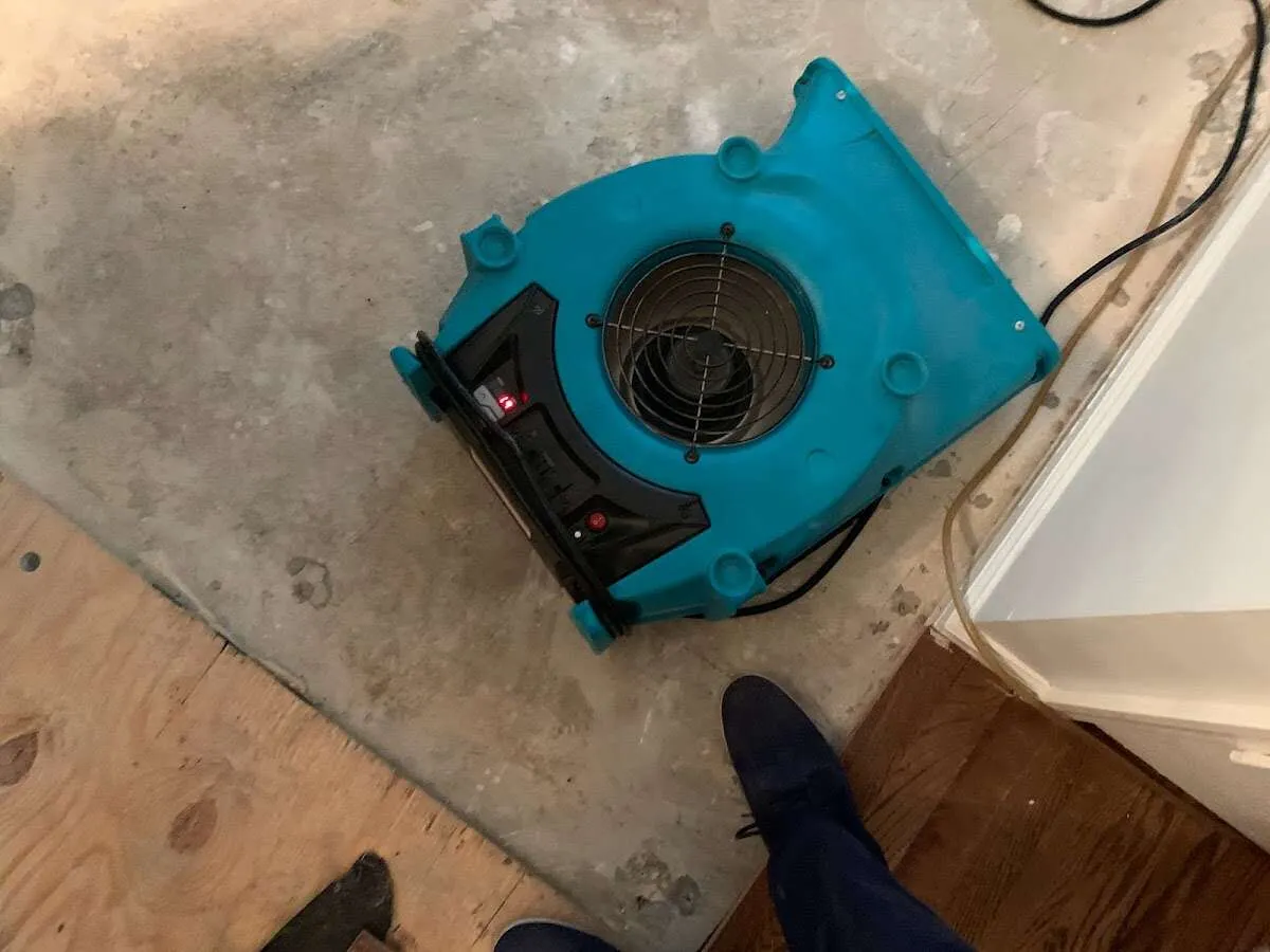 Air mover drying subfloor during Commercial Water Damage Restoration in Country Walk